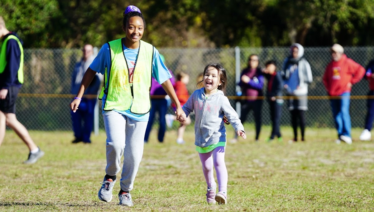 Volunteer with young runner